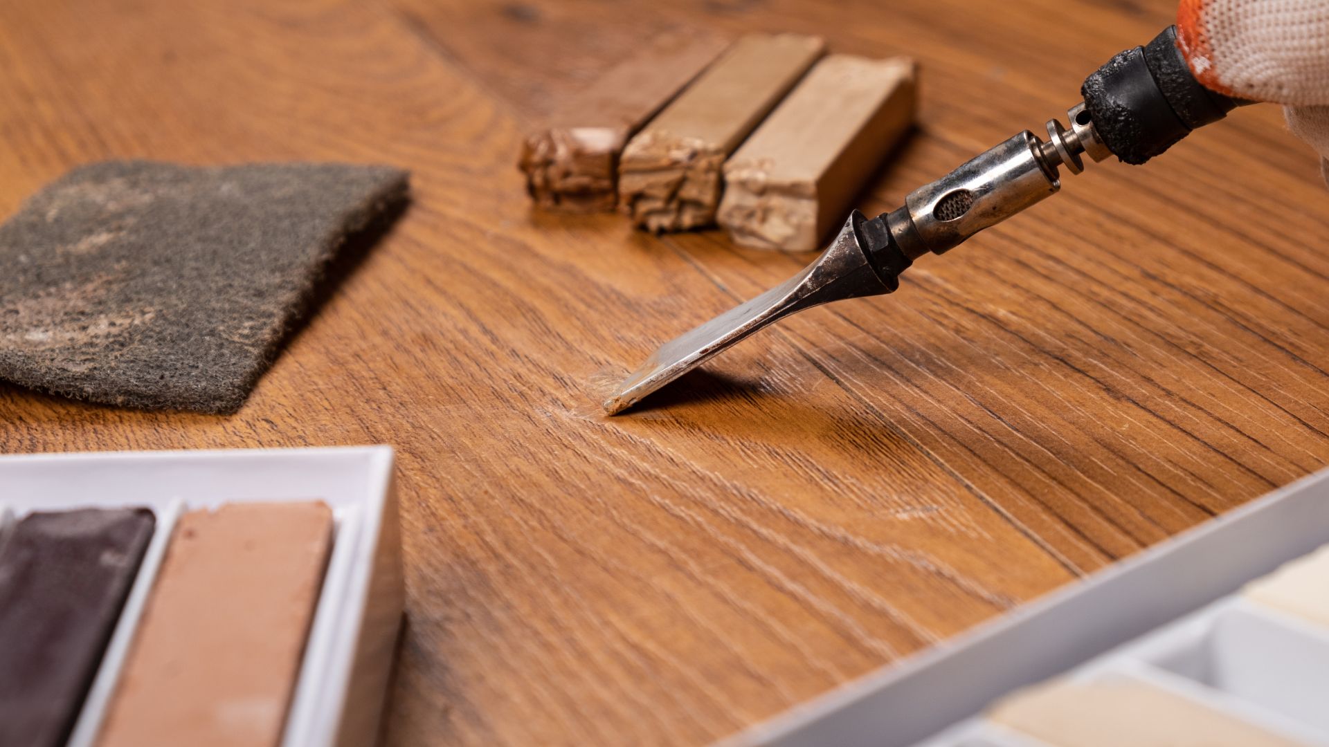 A person using a knife to cut a piece of wood