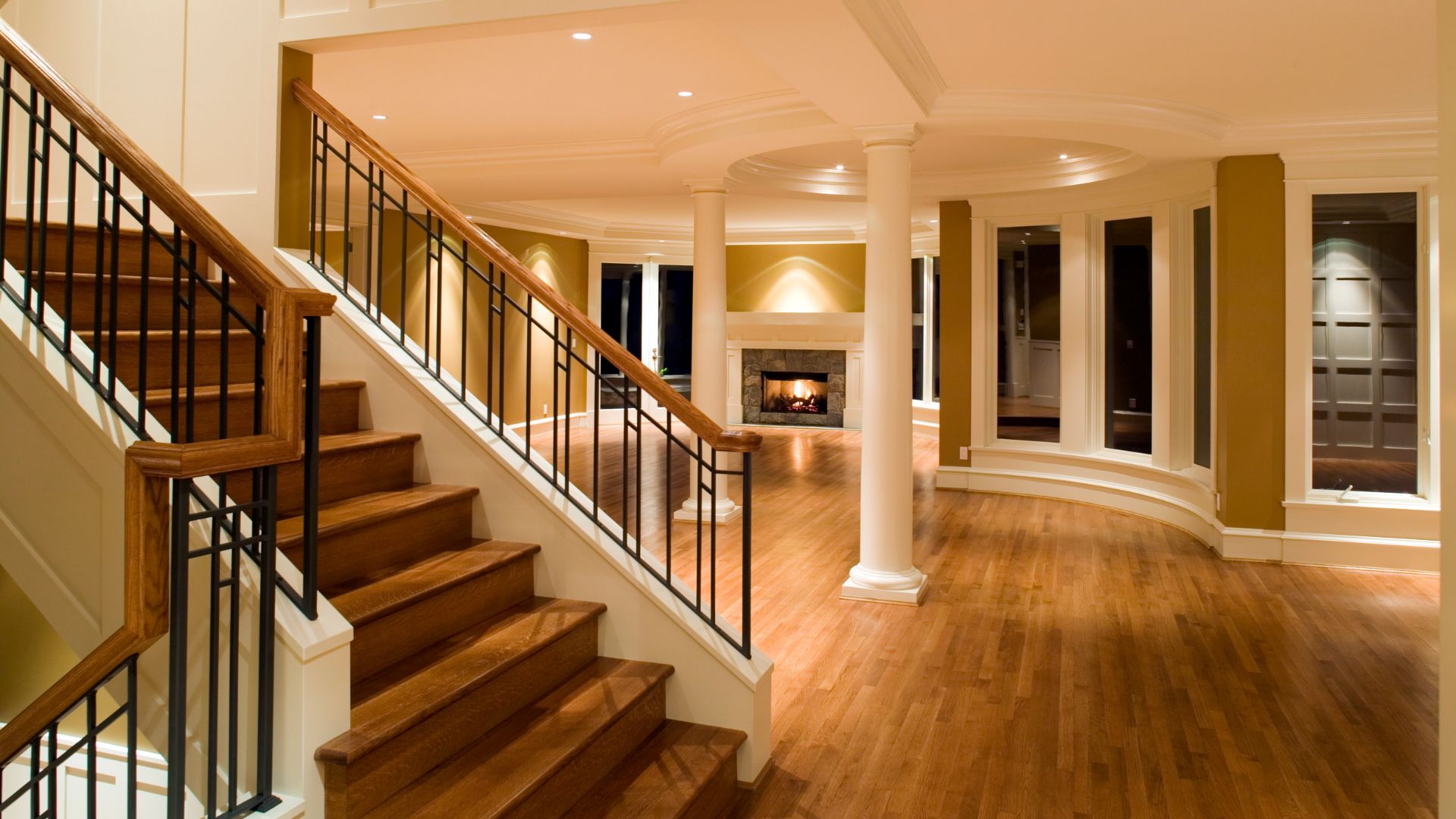 A room with a staircase and a fire place